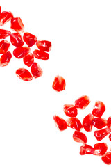 red pomegranate grains on white background