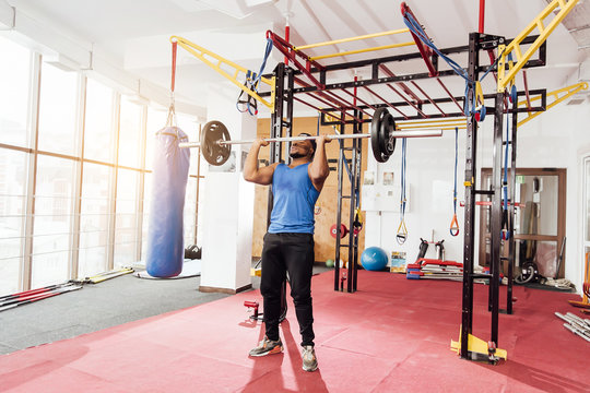 Health Club: Guy In A Gym Doing Weight Lifting