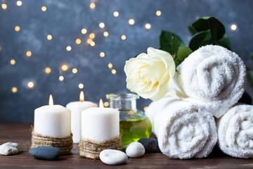 Obraz na płótnie Canvas Spa, beauty treatment and wellness background Towel Cosmetic Massage oil, flowers, lights and candel