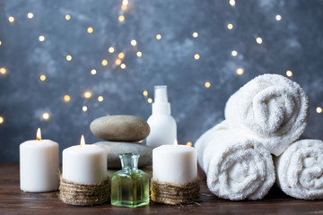 Fototapeta na wymiar Spa, beauty treatment and wellness background Towel Cosmetic Massage oil, flowers, lights and candel