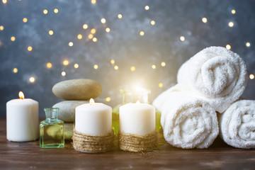 Fototapeta na wymiar Spa, beauty treatment and wellness background Towel Cosmetic Massage oil, flowers, lights and candel