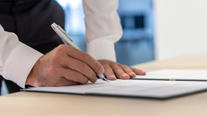 Business executive signing a document