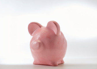 Pink piggy bank on a white background