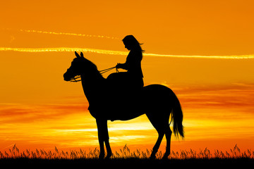 girl on horse at sunset