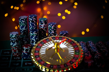 Fototapeta na wymiar Casino theme. High contrast image of casino roulette, and poker chips