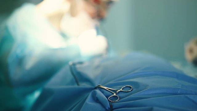 surgical instrument, wound dilator on the background of surgery in the operating room.