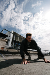 A man practices parkour, runs and jumps over obstacles