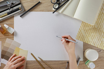 Collage view from above. View on top. Workspace artist or designer. paper on the wooden table....
