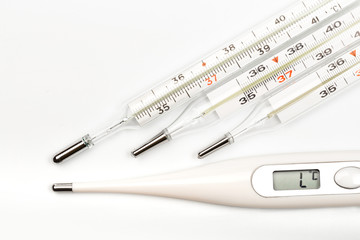 mercury and electrick thermometers on white background close up view