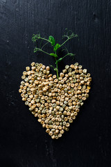 microgreen peas grain and germinated sprout heart concept