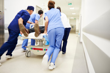 Rear view of doctors running for the surgery