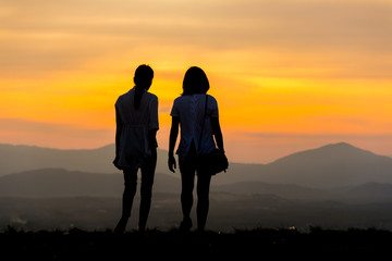 Silhouette young couple on sunset time.