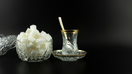 crystal glasses on the black background    cube sugar ,spoon