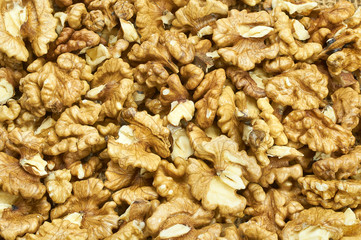Walnuts on natural burlap, walnut kernels in a wicker basket, nutty background