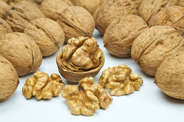 Walnuts on natural burlap, walnut kernels in a wicker basket, nutty background