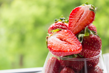 Strawberries in a glass. Summer berry dessert. Summer berry background. Copy space.