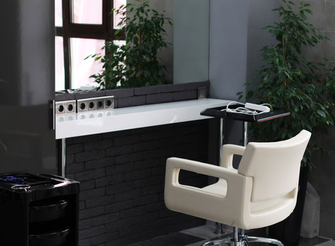 White Leather Chair In Front Of The Mirror In The Beauty Salon