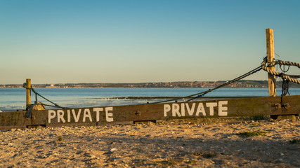Fototapeta premium Sign: Private, seen at Shellness Beach on the Isle of Sheppey, Kent, England, UK