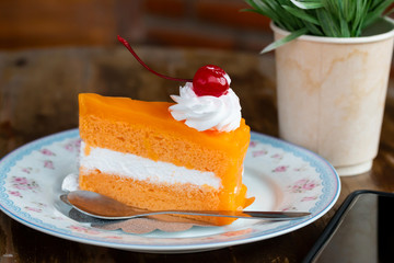Orange cake in coffee shop on table