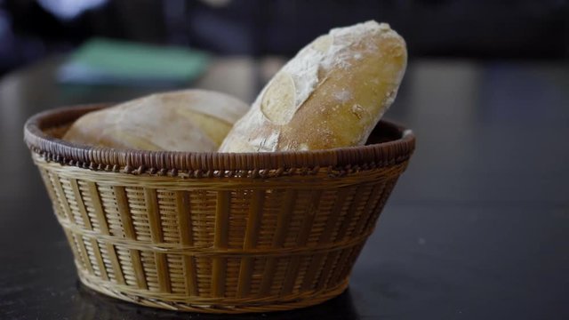 two loaves of crusty golden brown sourdough bread in a basket
