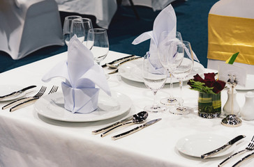 Table setting in the restaurant, water in the grass on the dining table, glass of water on table