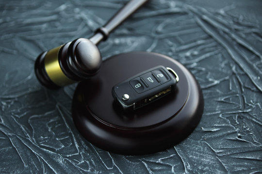 Car auction concept - gavel and car key on the wooden desk