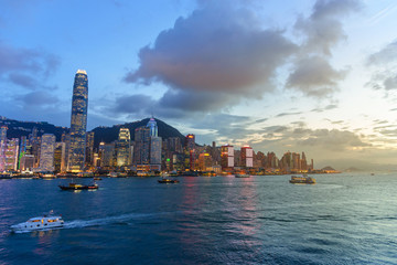 Naklejka premium Cityscape and skyline at Victoria Harbour at sunset time. Popular view point of Hong Kong city at twilight time
