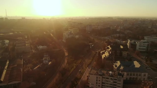 Forward aerial shot of Old Town Constanta City and harbor, Romania, Europe. Shot in spring during sunset and Golden Hour, revealing architecture and traffic while seagulls fly