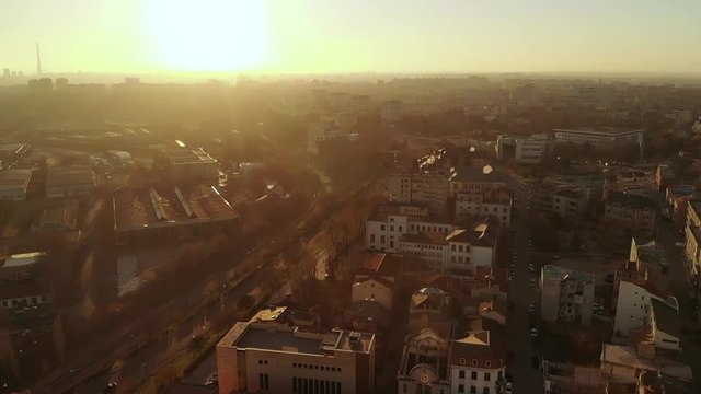 Forward aerial shot of Old Town Constanta City and harbor, Romania, Europe. Shot in spring during sunset and Golden Hour, revealing architecture and traffic while seagulls fly