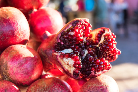 MARRAKECH, MOROCCO - NOVEMBER 19, 2018: Fresh pomegranates for sale on market in the jemaa el fna square in Marrakech, Morocco