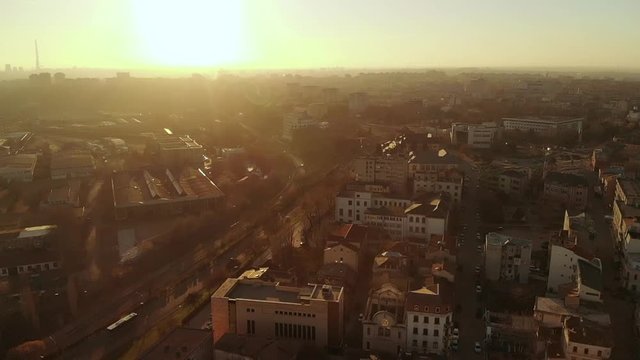 Forward aerial shot of Old Town Constanta City and harbor, Romania, Europe. Shot in spring during sunset and Golden Hour, revealing architecture and traffic while seagulls fly