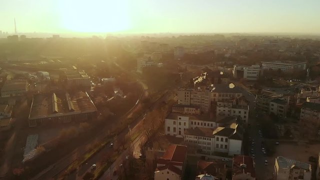 Forward aerial shot of Old Town Constanta City and harbor, Romania, Europe. Shot in spring during sunset and Golden Hour, revealing the traffic and architecture while seagulls fly