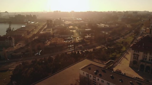 Pan aerial shot of Old Town Constanta City and harbor, Romania, Europe. Shot in spring during sunset and Golden Hour, revealing architecture and History Museum, while seagulls fly