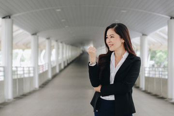 Successful and confident asian senior businesswoman leader standing over modern pathway background