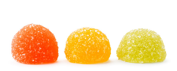 Three multicolored marmalade in sugar on a white, isolated. - obrazy, fototapety, plakaty