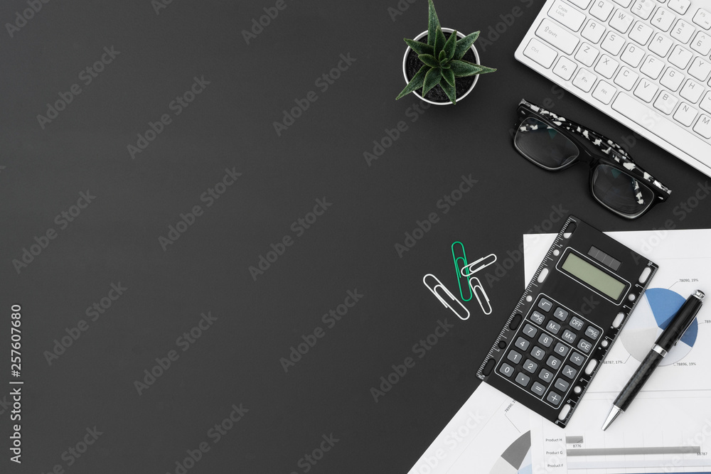 Poster flat lay office desktop work space of wireless keyboard, report graph and charts, pen, calculator an