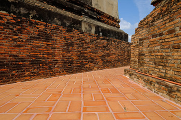 Brick walkway between two bases of pagoda in outdoor Buddhism temple