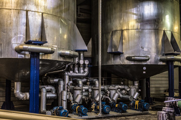 Tanks with air-injection equipment systems at an industrial plant. Industrial indoors view.