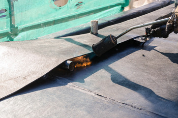 construction work during the renovation of a roof of a building with bituminous sheath