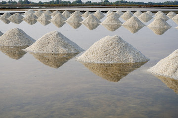 Heap of sea salt in a field prepared for harvest. Mass of salt in the salt sea farm