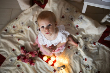 Fototapeta premium Cute girl child in gentle dress, top view. Garland