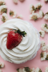 Fresh dessert with whisked cream and strawberry and flowers on table