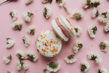 Fototapeta na wymiar Composition of two delicious macaroons and floral petals