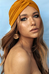 portrait of beautiful young woman with brown hair and freckles face