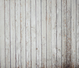 Abstract background of old painted white boards. From time, old age and dampness paint crumbles.