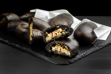 Patties stuffed with cabbage, potatoes and meat. Laid on a black slate.