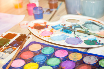 Watercolor paint palette.Old paint. Watercolor Paints and brushes with blank white paper sheet