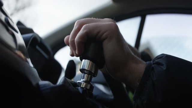 Male hand driving van, interior shot. Driving with hand on gear stick and change gear