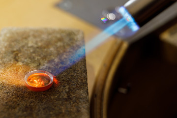 jeweler working a ring with the flame