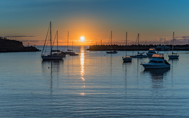 Fototapeta premium Sunrise and boats in the harbour